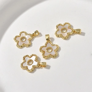 Detail of 18k gold plated flower pendants with white shell inlay for DIY jewelry making