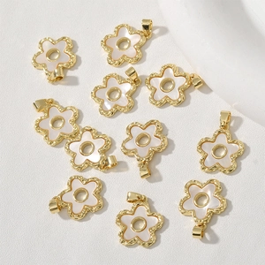 Detailed macro view of 18k gold plated shell flower pendants for DIY jewelry making