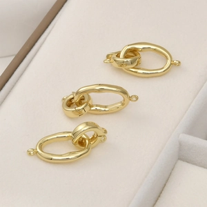 Detailed close-up of 14k gold plated textured square and oval jewelry toggle clasps