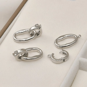 Close-up of silver-plated textured oval connectors for DIY bracelet and necklace making