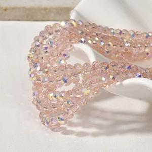 Macro shot of faceted light pink crystal beads with iridescent AB coating for DIY jewelry