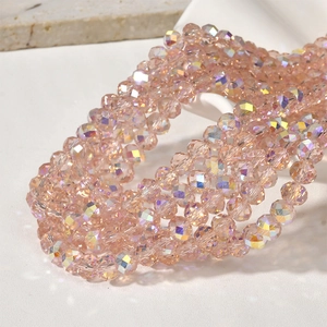 Close-up of pink faceted crystal beads with AB aurora coating for DIY jewelry making