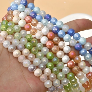 Macro view of 8mm multi-colored AB glass beads held in hand for jewelry DIY