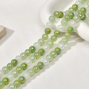 Macro view of 8mm iridescent green and white glass beads for DIY jewelry making