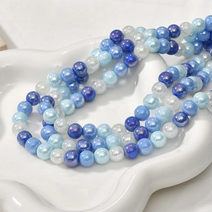 Close-up of 8mm iridescent blue and white glass beads with pearl-like luster for DIY jewelry