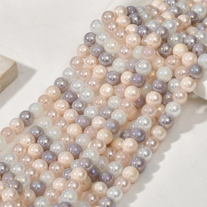 Macro shot of 8mm iridescent glass beads in pastel pink and lavender for jewelry DIY