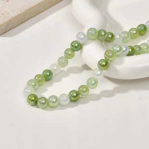 Detail of 8mm iridescent green and white glass beads for DIY jewelry making