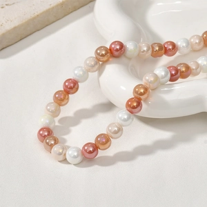 Macro detail of 8mm colorful glass pearl beads in a ceramic tray for DIY jewelry making