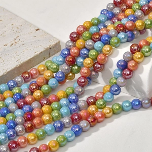 Macro shot of 8mm colorful pearlescent glass beads with iridescent glaze for DIY jewelry