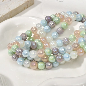 Close-up of 8mm iridescent macaron glass beads with aurora pearl finish for DIY jewelry