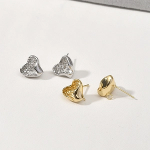 Macro detail of lava textured heart earrings with DIY loop in gold and silver finish