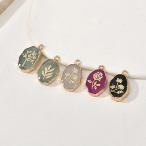 Ovalen goudkleurige kristallen hangers met gegraveerde planten voor DIY-sieraden
