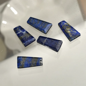 Macro detail of five trapezoid cut lapis lazuli stone pendants with pre-drilled holes