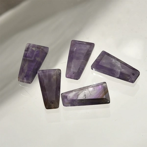 Macro detail of trapezoid cut natural purple amethyst stone pendants for jewelry making