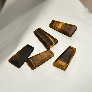 Macro shot of five natural tiger eye stone trapezoid pendants for DIY jewelry making