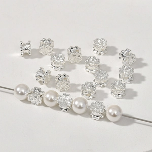 Silver flower spacer beads for DIY bracelets showing metallic luster and pearl pairing