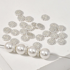Detail of silver gear spacer beads with pavé set zircons paired with white pearls