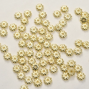 Macro shot of 14k gold-plated sunflower spacer beads for DIY jewelry and bracelets