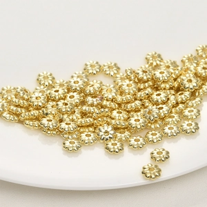 Macro shot of 14k gold-plated sunflower spacer beads for DIY jewelry making
