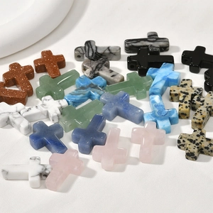 Macro detail of assorted colorful cross-shaped gemstone beads with side-drilled holes for DIY