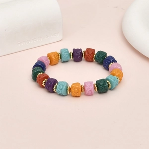 Handmade lion head beaded bracelet with multi-colored engraved synthetic coral beads