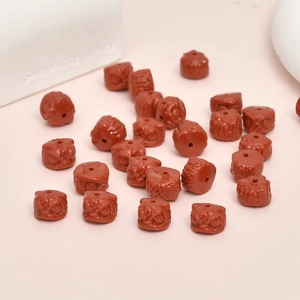 Macro shot of red lion dance carved synthetic beads for DIY jewelry making