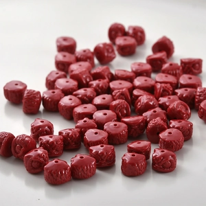 Macro detail of red carved lion head spacer beads with precise holes for DIY jewelry