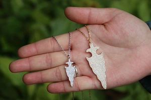 Detalle de colgantes de flecha en oro y plata con cristales brillantes micro-pavé
