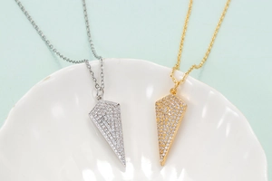 Arrow pendant necklaces in gold and silver finish with micro-pave cubic zirconia crystals
