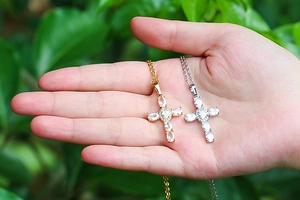 Close-up of gold and silver hip hop cross pendants with sparkling zircon stones