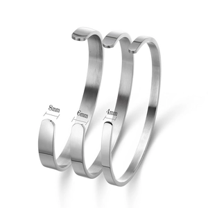 Detail view of open stainless steel bangles in 8mm, 6mm, and 4mm widths