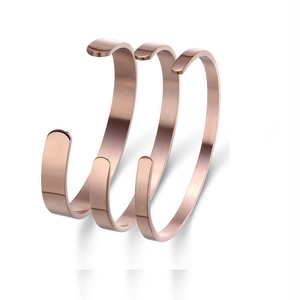 Three minimalist rose gold stainless steel open cuff bracelets with a matte brushed finish