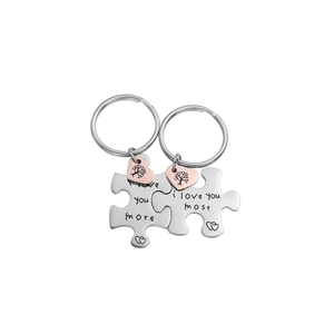 Puzzle-shaped stainless steel couple keychain set with heart pendants and I love you engraving