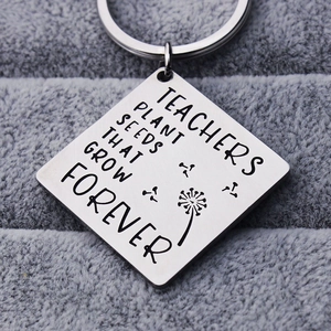 Polished stainless steel Tree of Life keychain with Teacher's quote on a velvet base