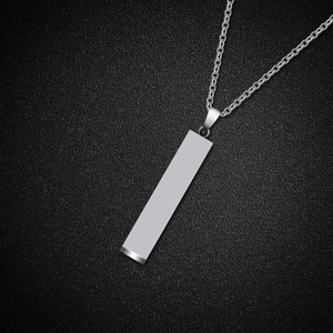 Close-up of a sleek silver rectangular bar pendant necklace with polished metal texture