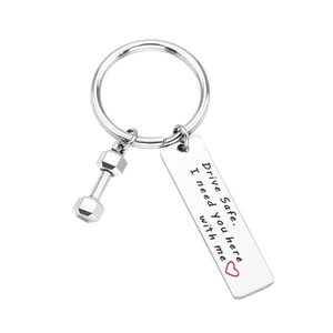 Titanium steel drive safe keychain with dumbbell charm and heart message on white background
