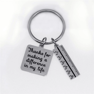 Detail of silver ruler pendant and engraved thanks message on the stainless steel keychain