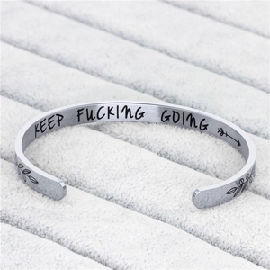 Polished silver C-shaped cuff bracelet with KEEP FUCKING GOING inspirational engraving