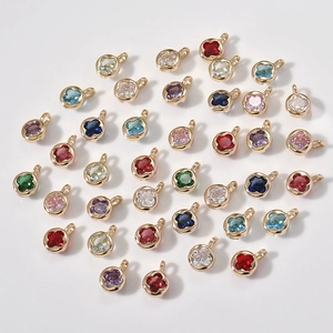 Detailed view of 14k gold-plated clover charms with colorful zircon for DIY jewelry