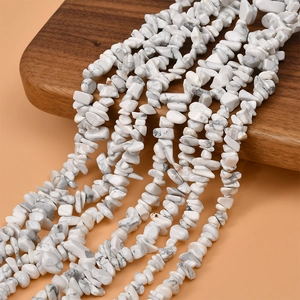 Close-up of natural white howlite stone chips for DIY jewelry making on wooden display