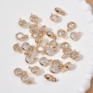 Macro shot of 14k gold plated four-leaf clover crystal charms for jewelry making