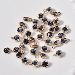 Detailed view of 14k gold plated four-leaf clover pendants with blue crystal stones