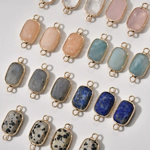 Close-up of faceted natural stone connectors with gold plated edges for DIY jewelry
