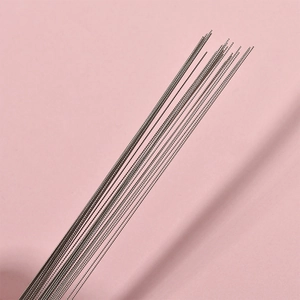 Macro shot of ultra-fine silver metal beading needles for DIY jewelry making and crafts