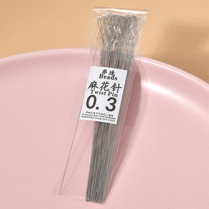 Macro shot of 0.3mm ultra-thin silver twist pins for DIY crystal beading on pink plate