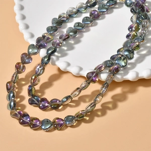 Macro shot of colorful iridescent heart-shaped glass beads for DIY jewelry making