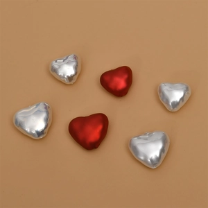 Detailed view of red and silver heart-shaped pearl DIY jewelry craft accessories