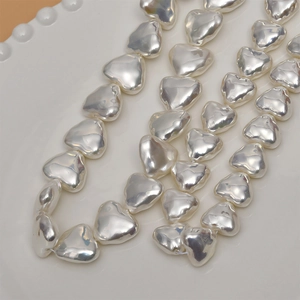 Macro shot of heart-shaped baroque faux pearl beads for DIY jewelry making material