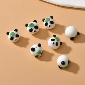 Handmade lampwork glass panda beads for DIY jewelry making featuring black white and green