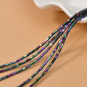 Macro shot of 2mm iridescent square hematite beads in rainbow colors for DIY jewelry
